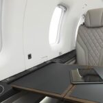 Interior cabin of Pilatus PC 12 NGX aircraft showing pull out table and seat