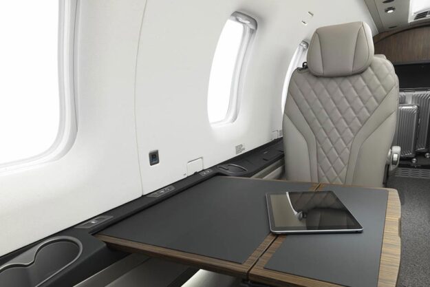 Interior cabin of Pilatus PC 12 NGX aircraft showing pull out table and seat